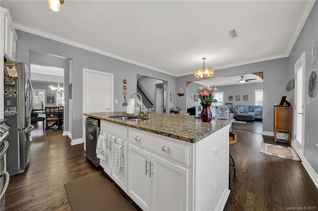 2162 Bluebell Way Tega Cay, SC 29708 - Photo 9 of 37 a open kitchen with stainless steel appliances kitchen island granite countertop a large island in the center