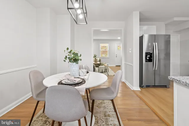 a dining room with furniture and wooden floor