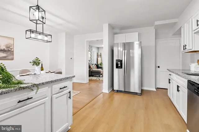 a spacious bathroom with a granite countertop sink a mirror and a shower