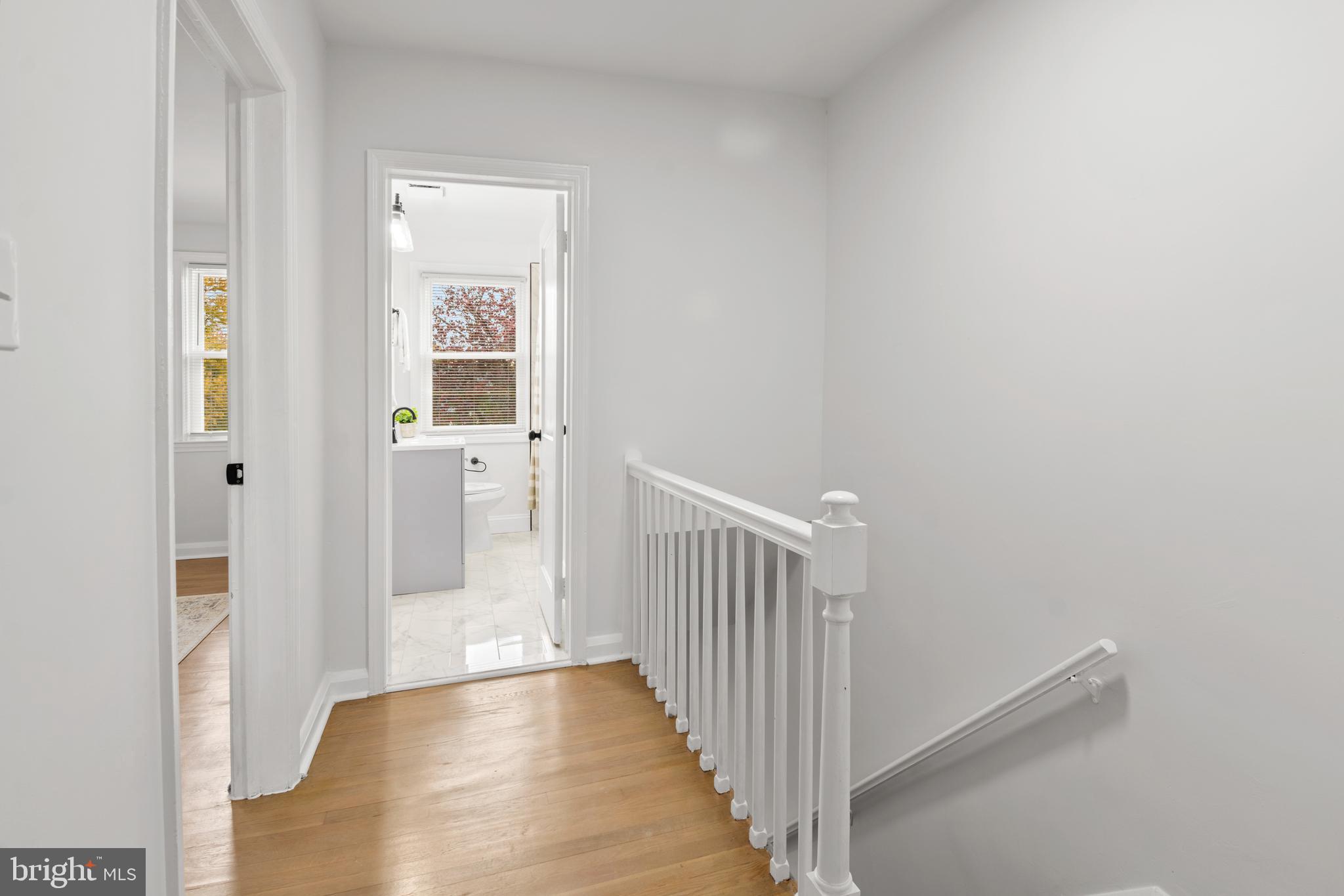 1212 Cedarcroft Road Baltimore, MD 21239 - Photo 20 of 42 a view of a hallway with wooden floor and a bathroom