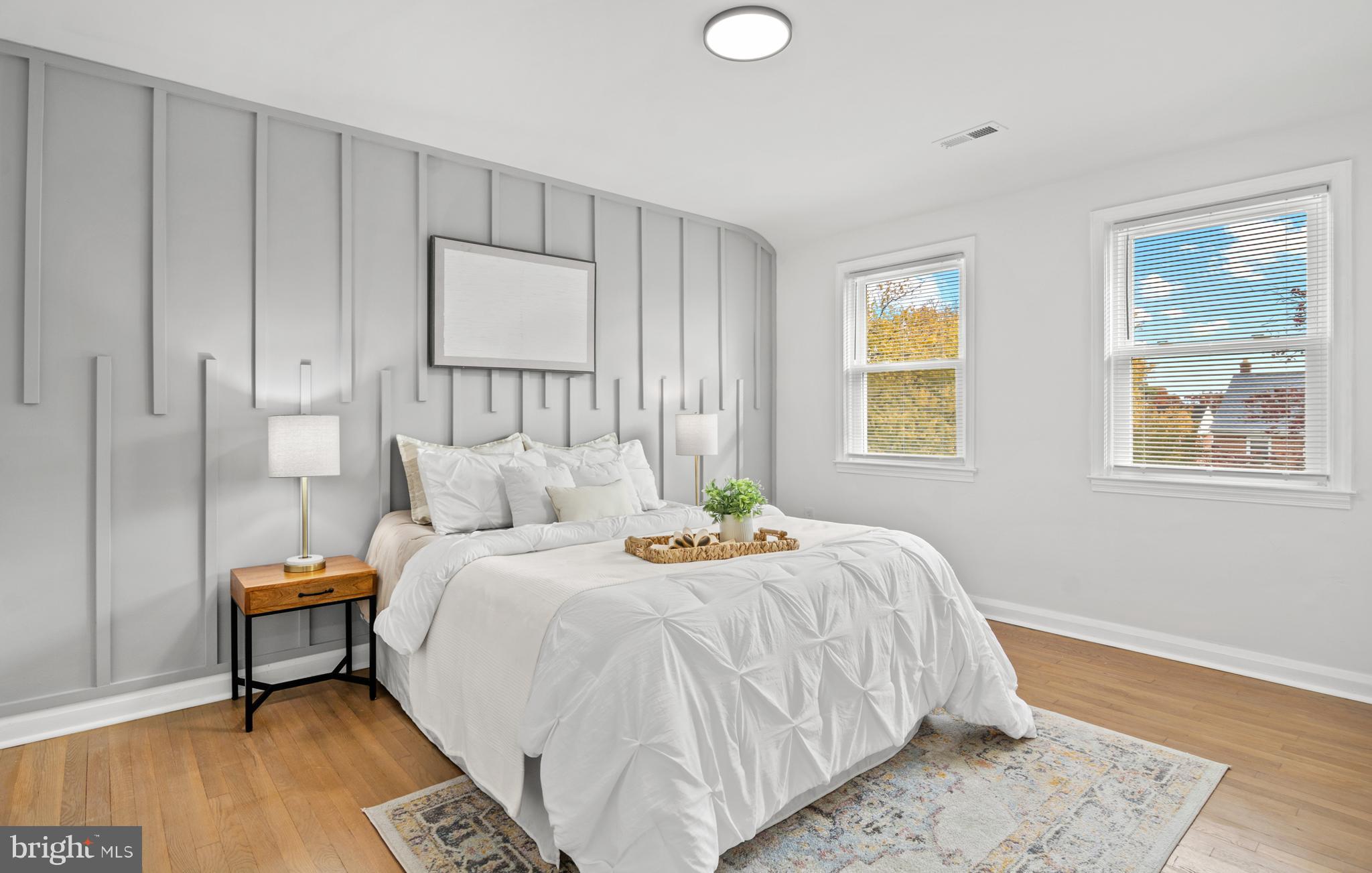 1212 Cedarcroft Road Baltimore, MD 21239 - Photo 22 of 42 a bedroom with a bed and wooden floor