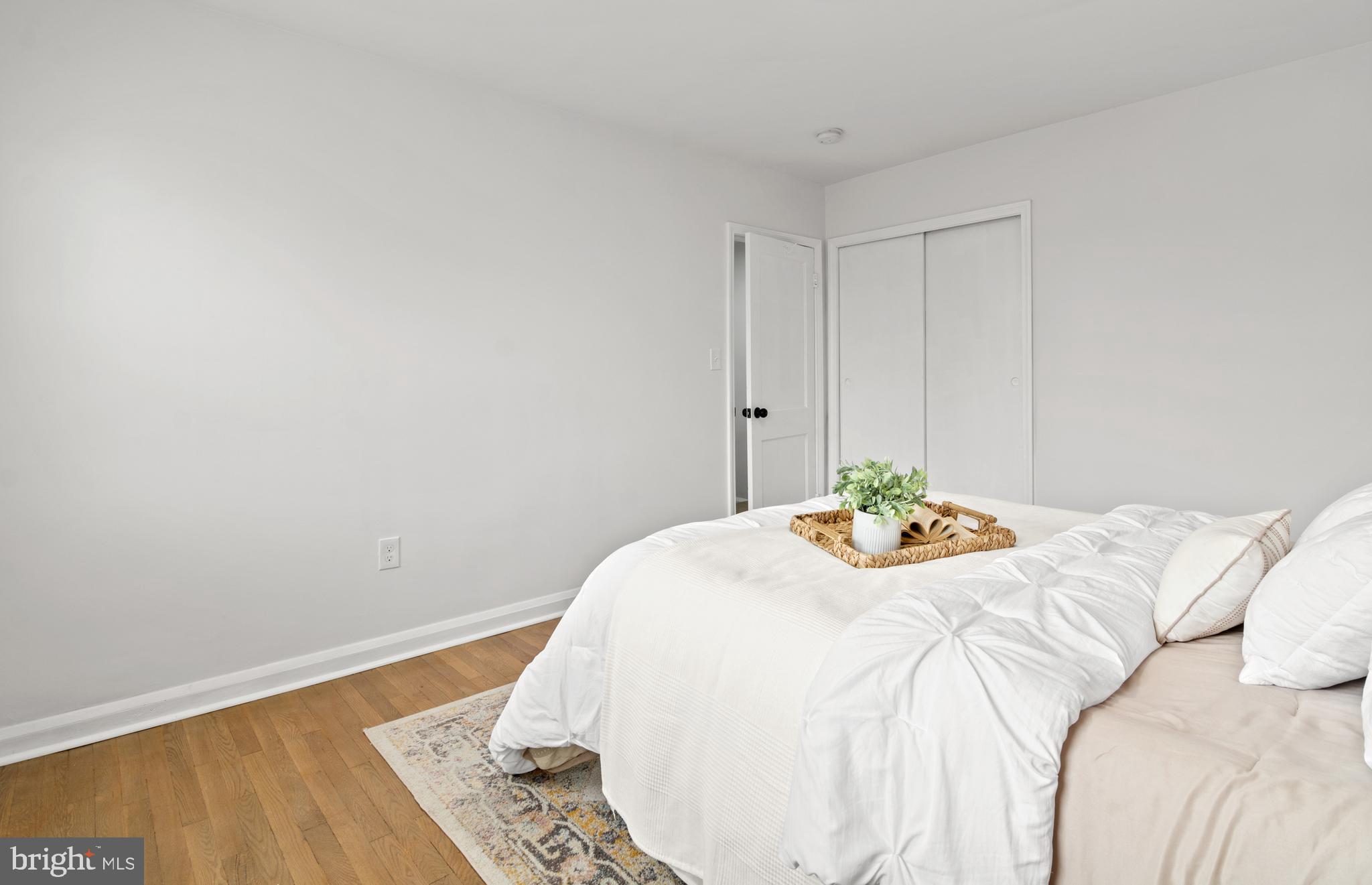 1212 Cedarcroft Road Baltimore, MD 21239 - Photo 24 of 42 a bedroom with a bed and a wooden floor