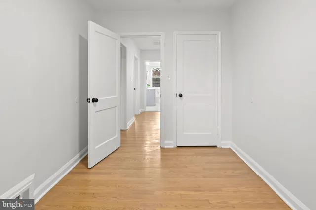 a view of an empty room with wooden floor