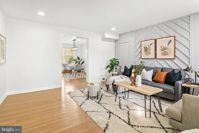 a living room with furniture and flowers