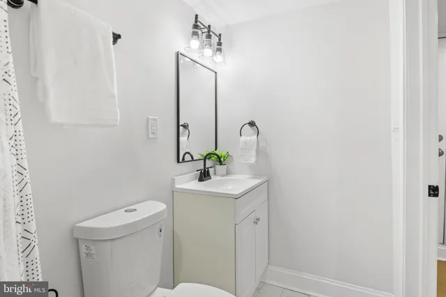 a view of a yard with plants and trees