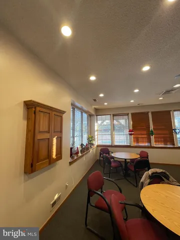a kitchen with a table chairs refrigerator and microwave