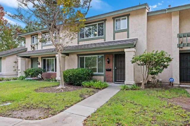 a front view of a house with a yard and porch
