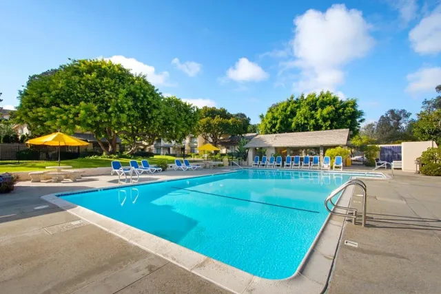 an outdoor space with swimming pool and furniture
