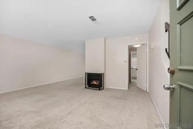 a view of an empty room with a fireplace