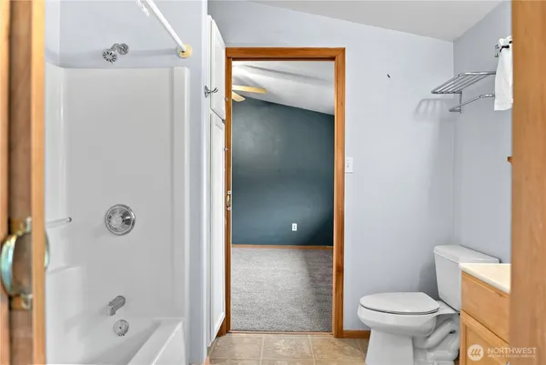 a bathroom with a granite countertop toilet a sink and shower