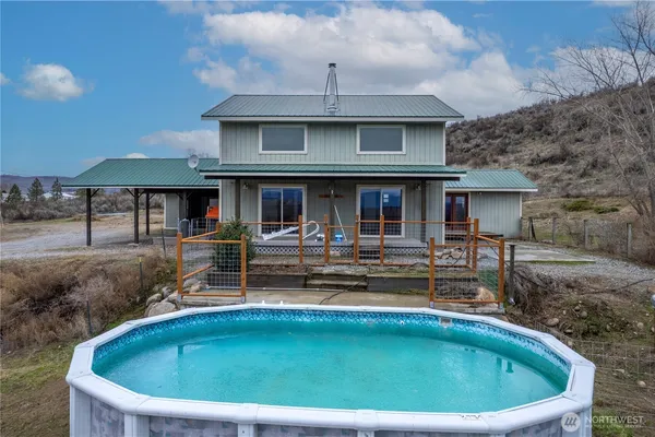 a view of house with swimming pool outdoor seating