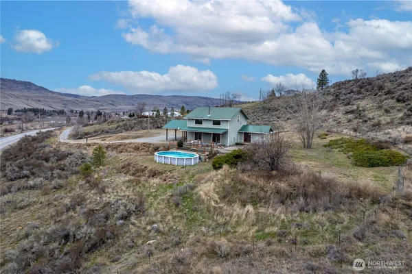 a view of a big house with a mountain in the background