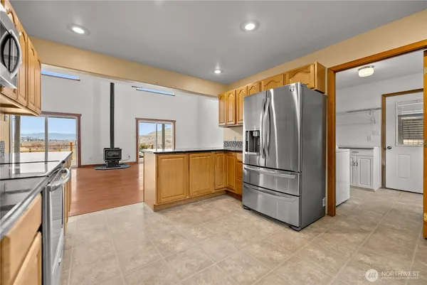 a kitchen with stainless steel appliances granite countertop a refrigerator and a stove