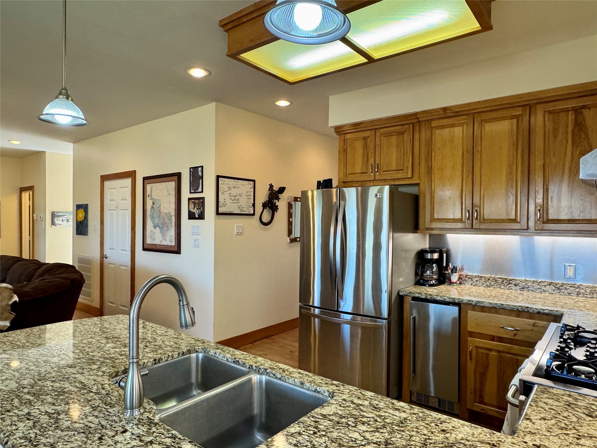 55 Lake Road Huntsville, TX 77320 - Photo 14 of 50 a kitchen with stainless steel appliances granite countertop a refrigerator a stove top oven and a sink