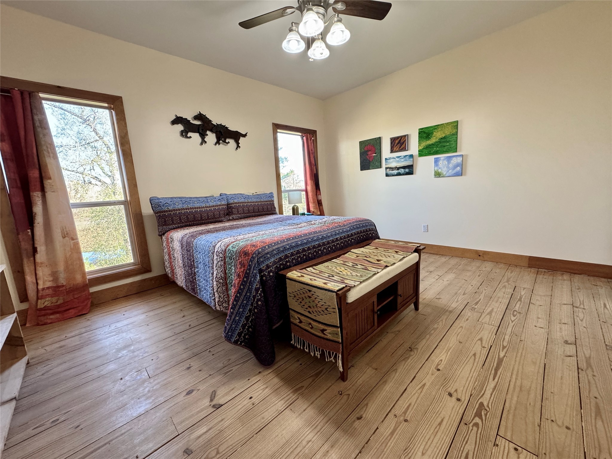 55 Lake Road Huntsville, TX 77320 - Photo 16 of 50 a bedroom with a bed and a chandelier