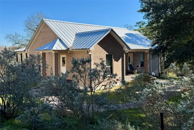 a view of a house with yard and sitting area