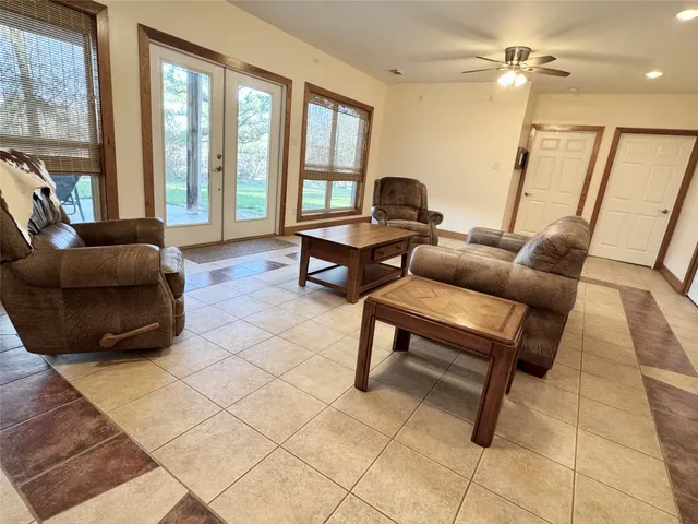 a living room with furniture and a floor to ceiling window