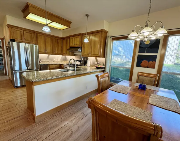 a kitchen with sink refrigerator and microwave