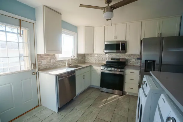 a kitchen with a sink stove and refrigerator