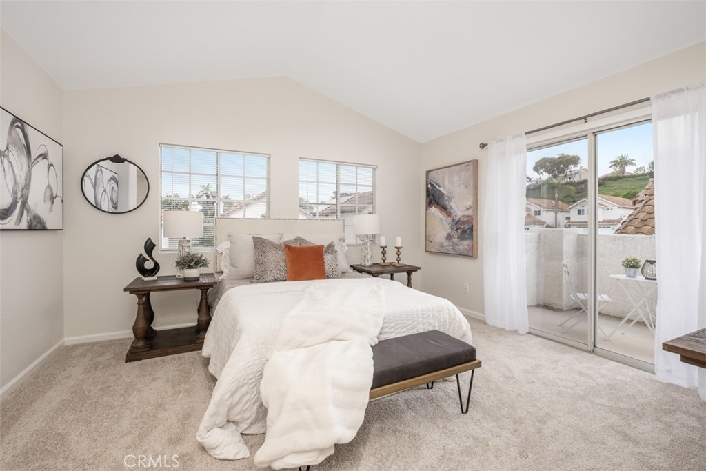 10 Finca San Clemente, CA 92672 - Photo 13 of 27 a bedroom with a bed and a chandelier