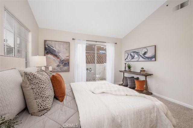 a bedroom with a bed couch and a window