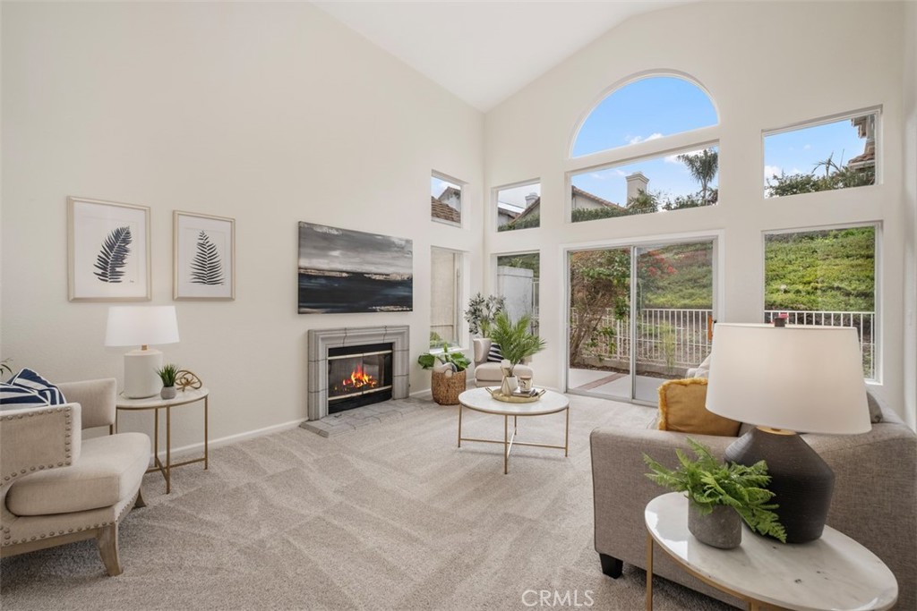 10 Finca San Clemente, CA 92672 - Photo 2 of 27 a living room with furniture a fireplace and a flat screen tv