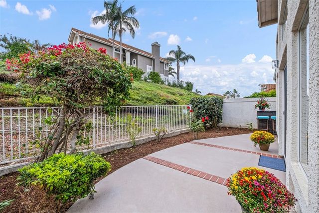 a view of a patio with a table and chairs and potted plants