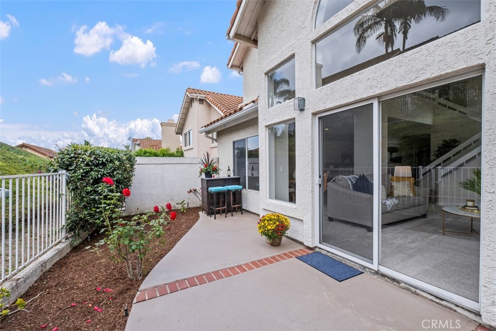 10 Finca San Clemente, CA 92672 - Photo 22 of 27 a view of a patio with a table and chairs and potted plants