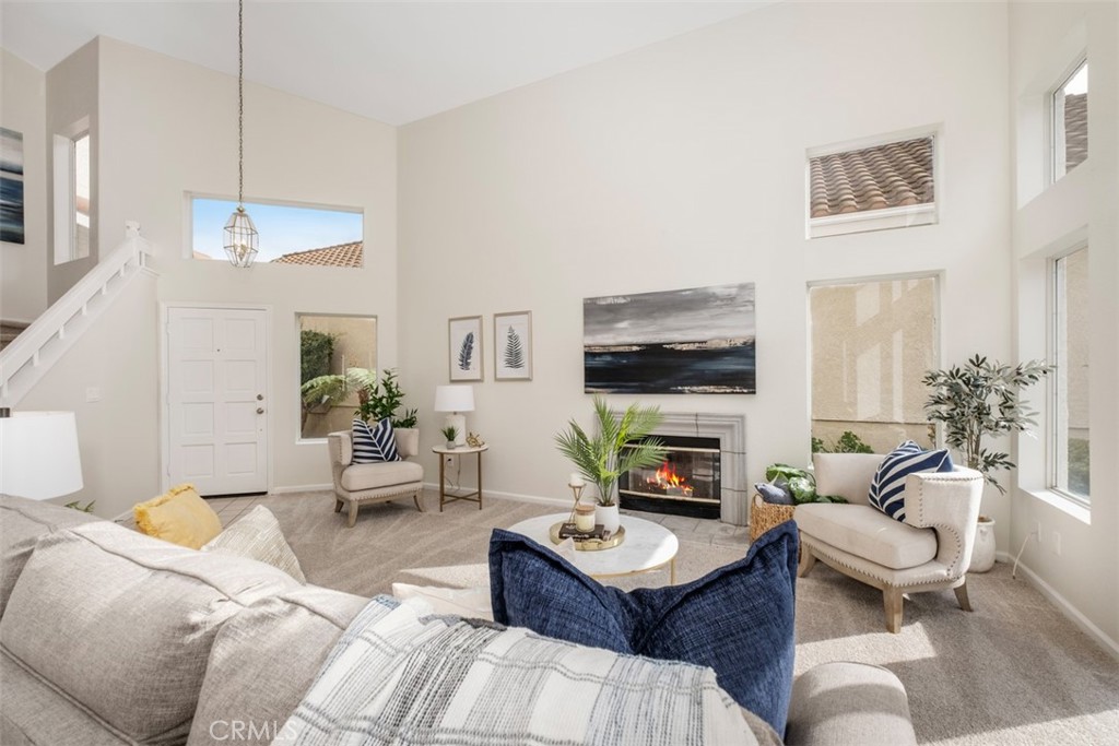 10 Finca San Clemente, CA 92672 - Photo 4 of 27 a living room with furniture a fireplace and a flat screen tv