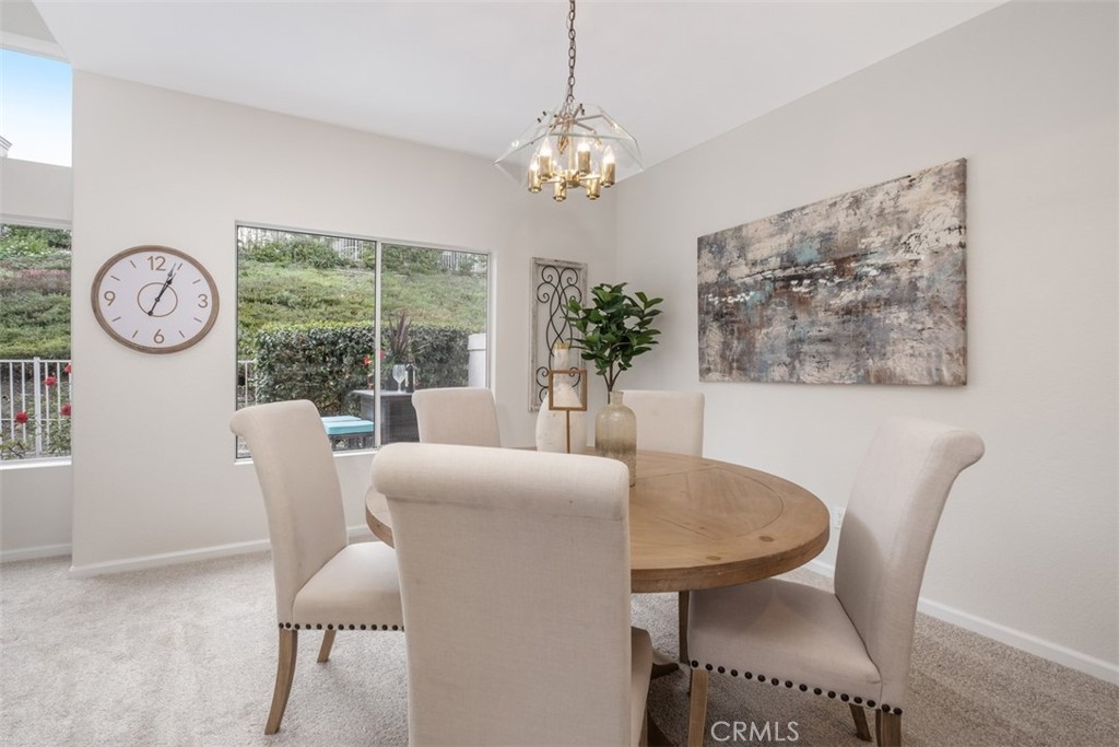 10 Finca San Clemente, CA 92672 - Photo 6 of 27 a dining room with furniture a chandelier and window