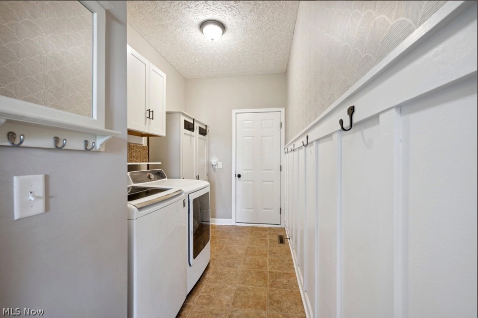 405 East Luchsinger Road Port Clinton, OH 43452 - Photo 28 of 40 Laundry room with independent washer and dryer, cabinets, light tile floors, and a textured ceiling