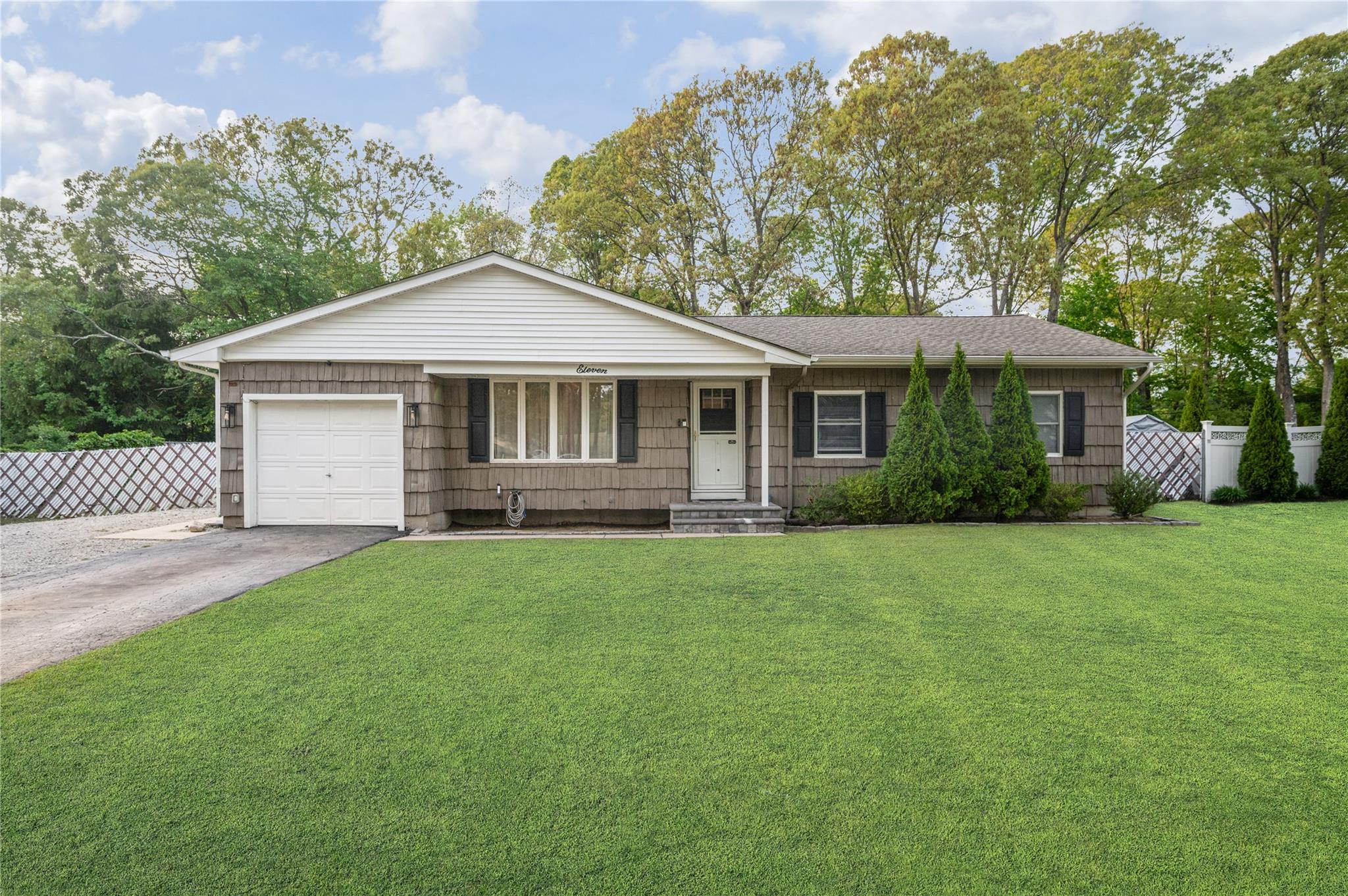 a front view of a house with a garden