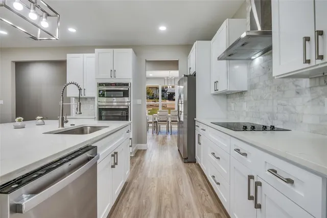 a large kitchen with stainless steel appliances granite countertop a lot of counter space a sink and a stove