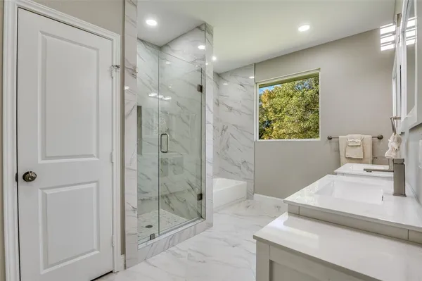 a bathroom with a shower sink and mirror