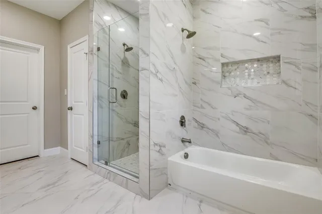 a bathroom with a bathtub and a shower