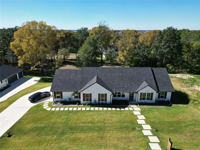 a aerial view of a house next to a big yard