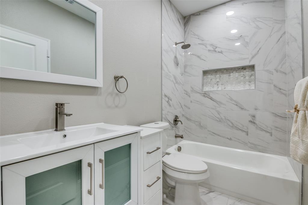 206 Splitrail Drive Mabank, TX 75143 - Photo 21 of 28 Full bathroom featuring shower / bath combination, vanity, and marble look tiles
