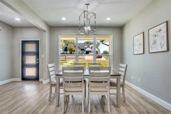 a view of a dining room with furniture wooden floor and chandelier