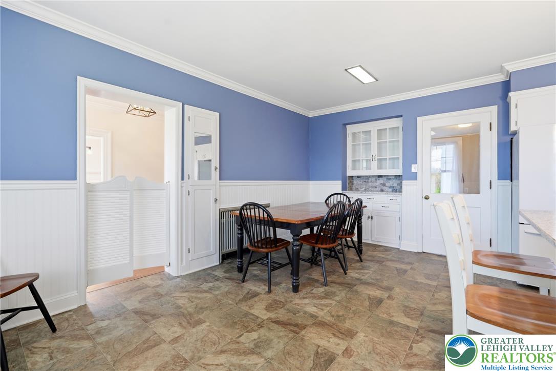 4682 Steuben Road Bethlehem, PA 18020 - Photo 19 of 79 A cheerful kitchen with vibrant blue walls and wainscoting offers ample space for dining and entertaining.