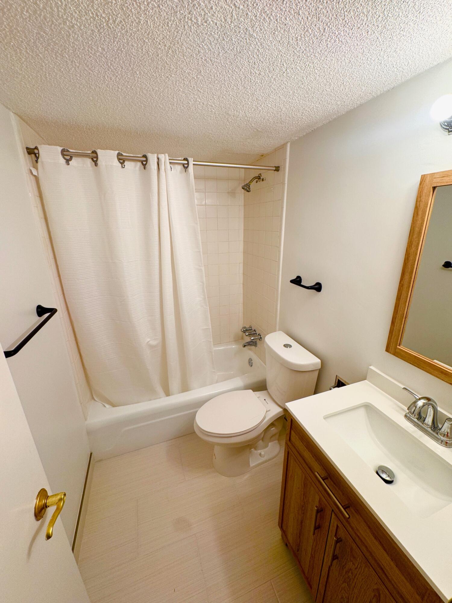 2565 South Ocean Boulevard, Unit 2060 Palm Beach, FL 33480 - Photo 15 of 17 a bathroom with a double vanity sink and mirror with toilet