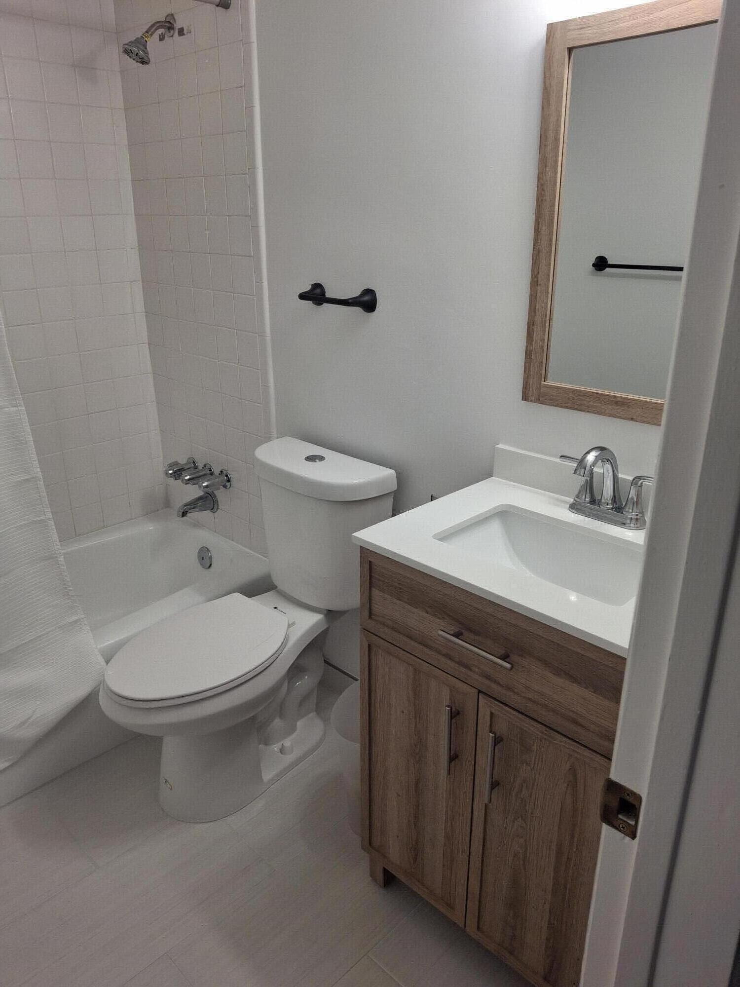2565 South Ocean Boulevard, Unit 2060 Palm Beach, FL 33480 - Photo 16 of 17 a bathroom with a sink toilet and mirror
