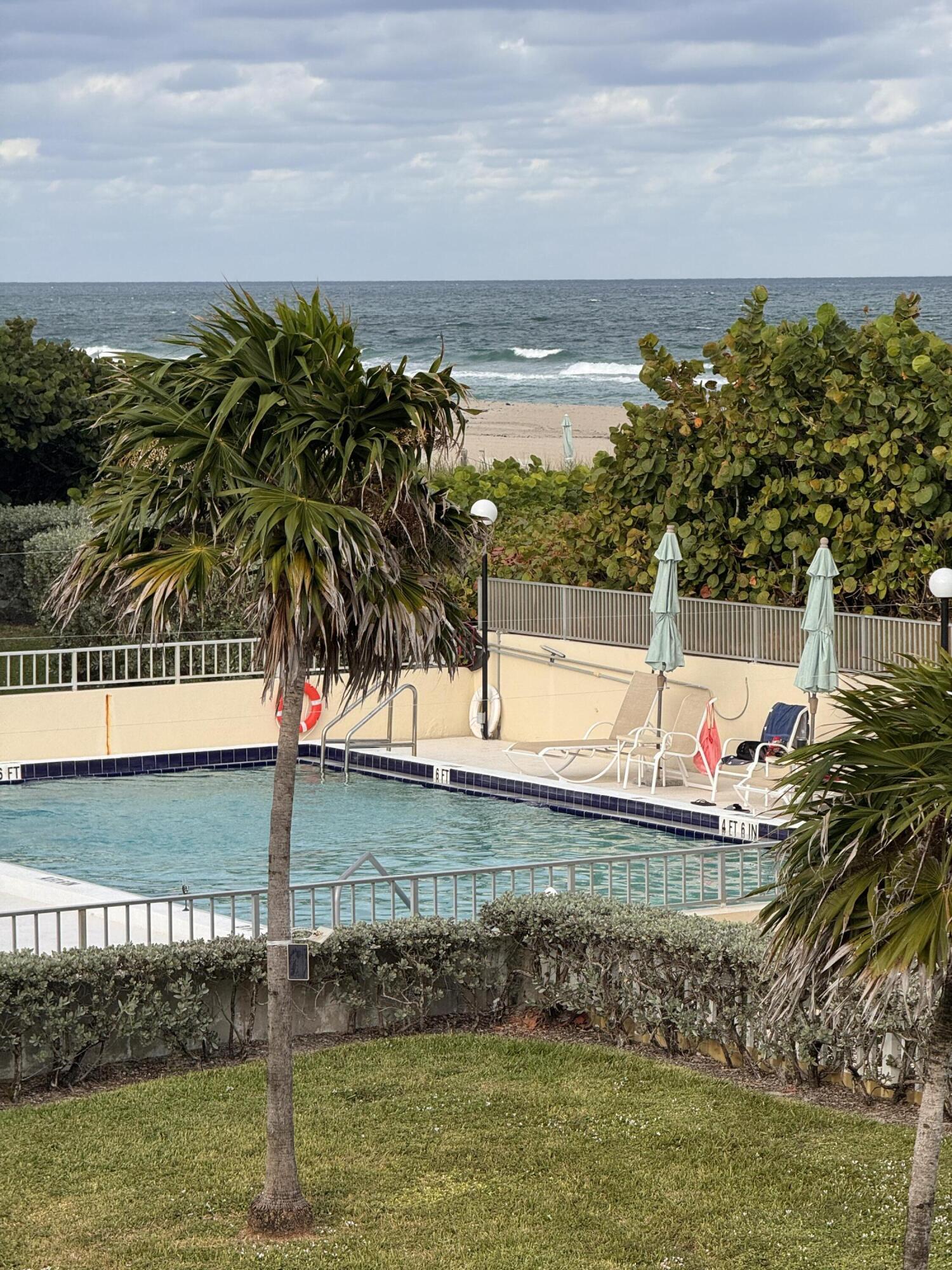 2565 South Ocean Boulevard, Unit 2060 Palm Beach, FL 33480 - Photo 4 of 17 a view of swimming pool with a yard and seating area
