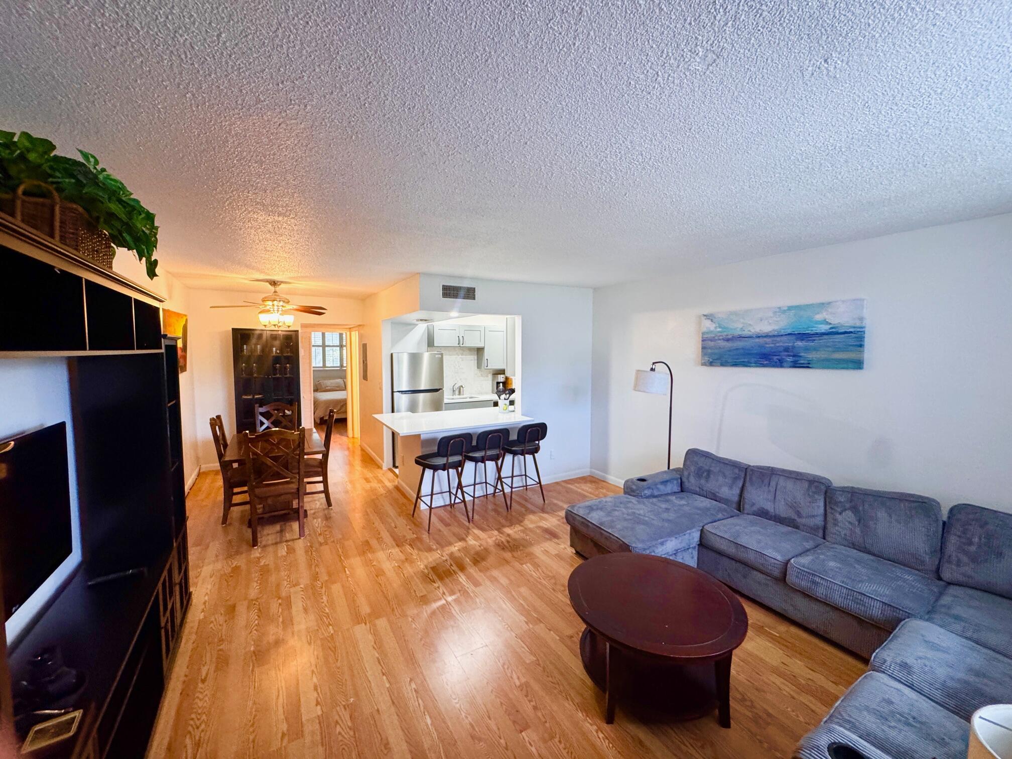 2565 South Ocean Boulevard, Unit 2060 Palm Beach, FL 33480 - Photo 8 of 17 a living room with furniture and a wooden floor