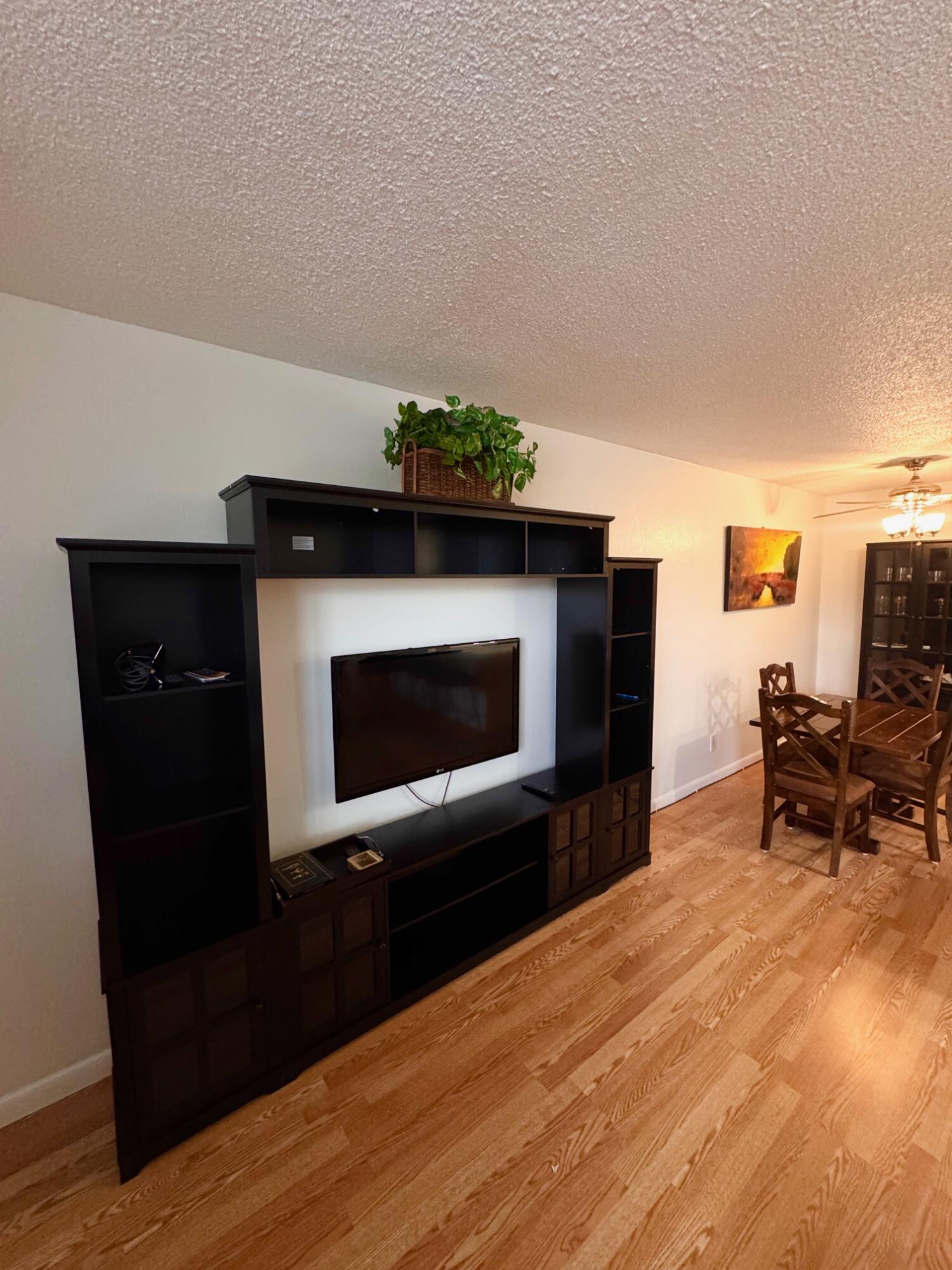 2565 South Ocean Boulevard, Unit 2060 Palm Beach, FL 33480 - Photo 9 of 17 a living room with a fireplace and a table