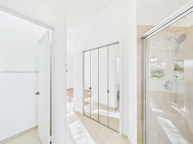 a bathroom with a glass shower door