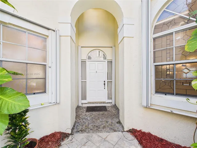 a view of a hallway to a livingroom with furniture