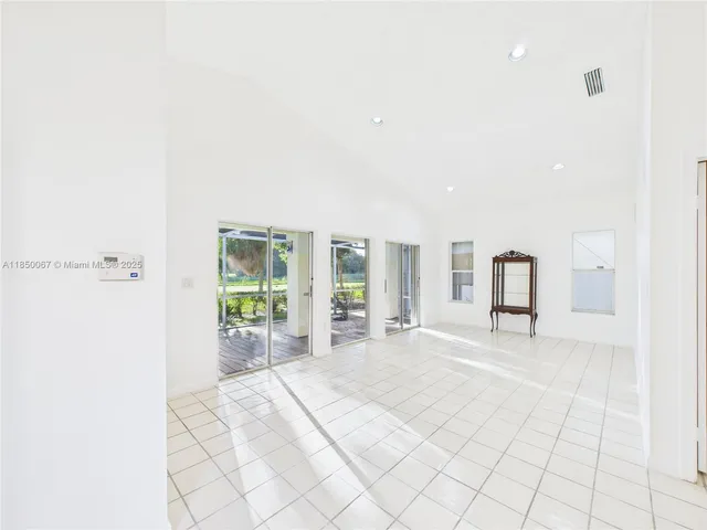 a large bedroom with a large bed and a large window