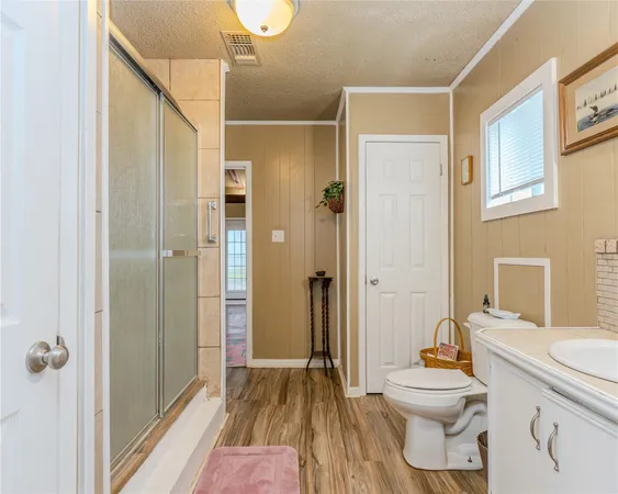 a bathroom with a toilet sink a shower and a mirror