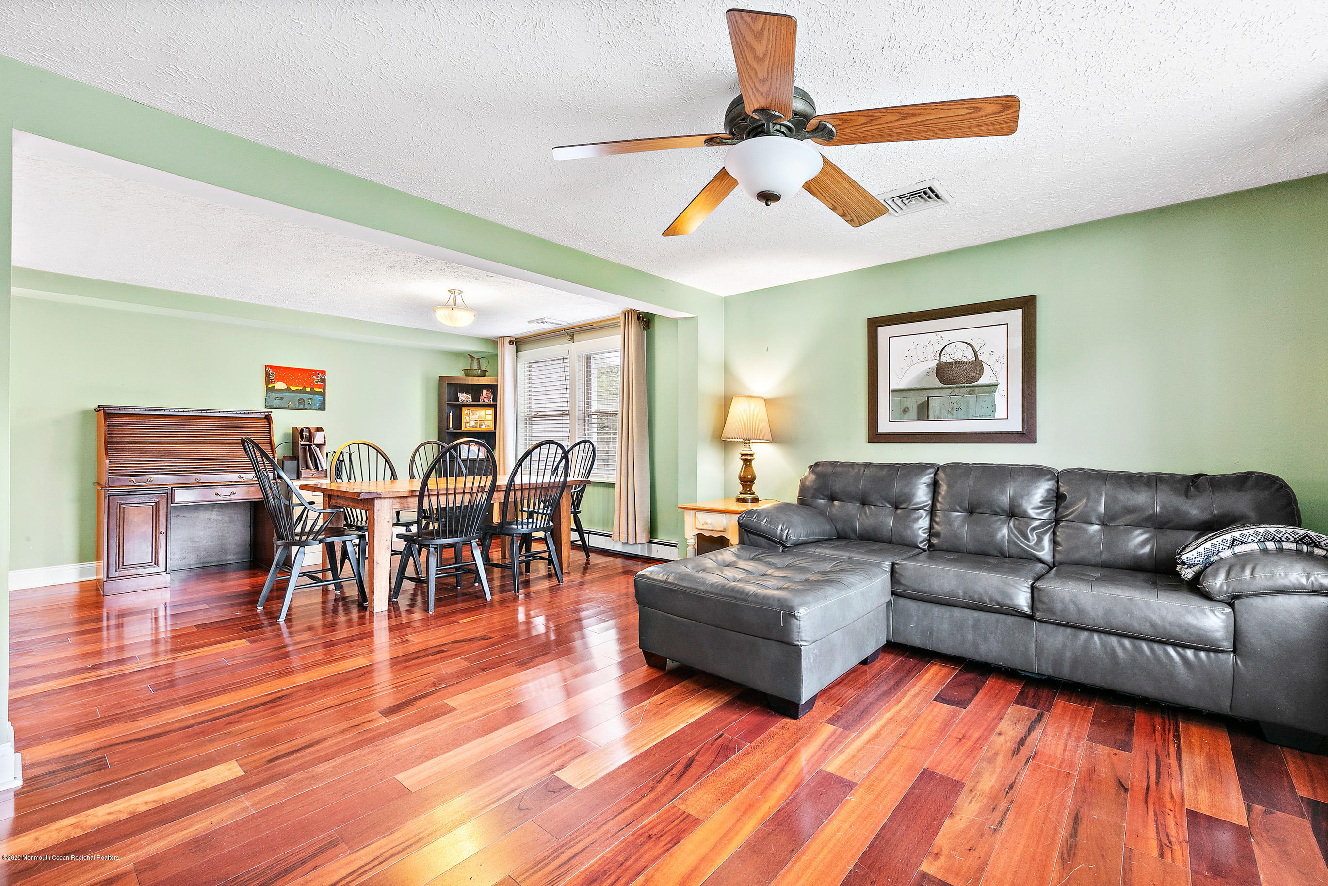 121 Wave Road Manahawkin, NJ 08050 - Photo 11 of 40 a living room with furniture kitchen view and a wooden floor
