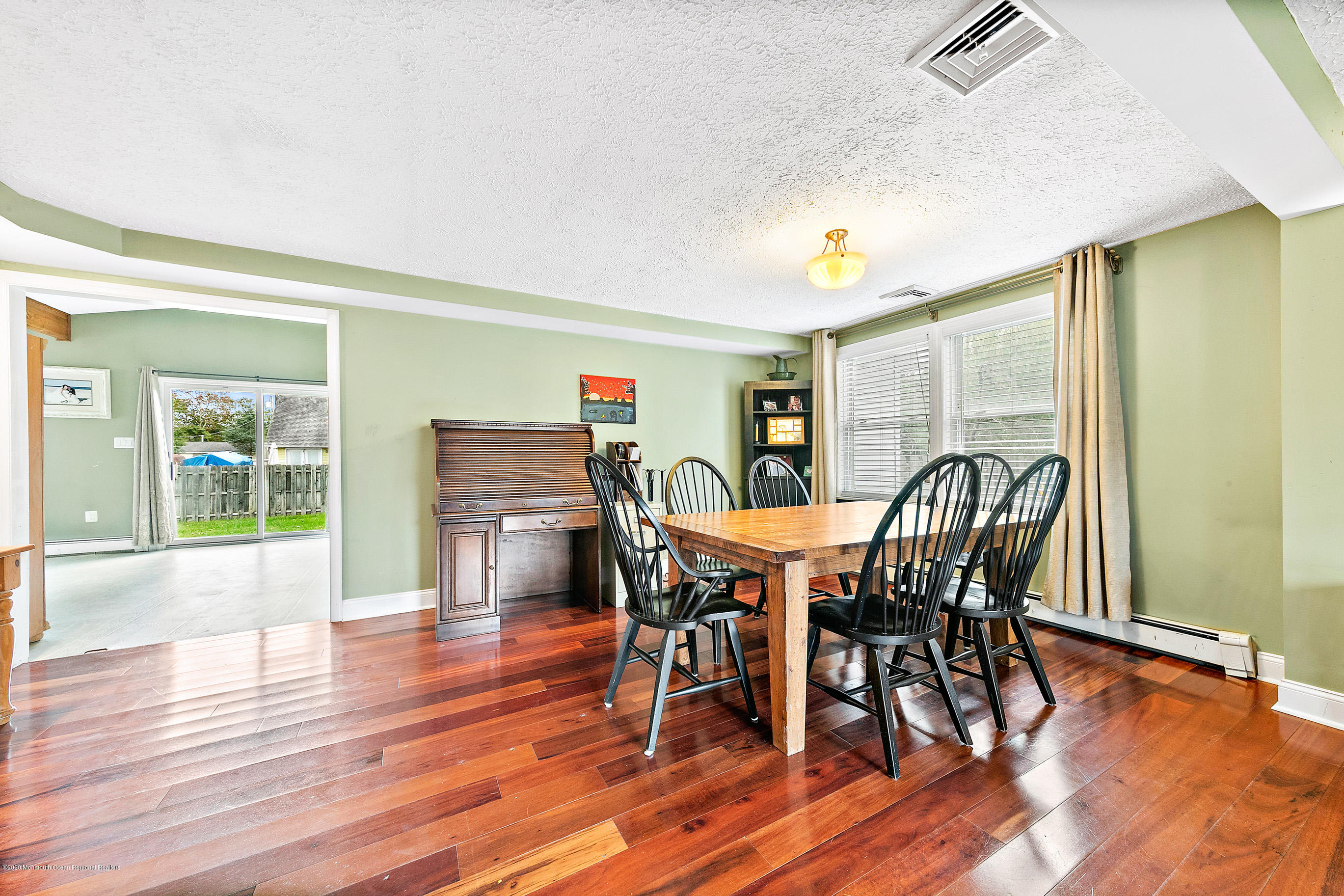 121 Wave Road Manahawkin, NJ 08050 - Photo 12 of 40 a view of a dining room with furniture and wooden floor